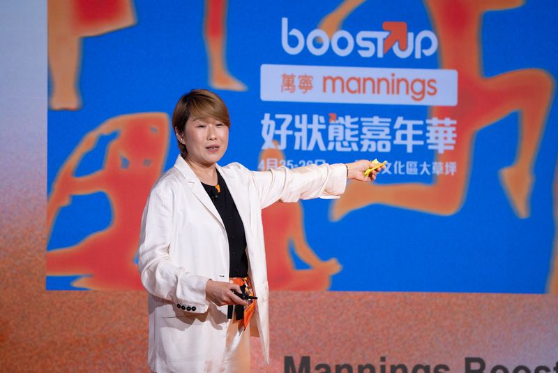 Keynote speaker on stage at the Mannings Boost Up Carnival, event photography